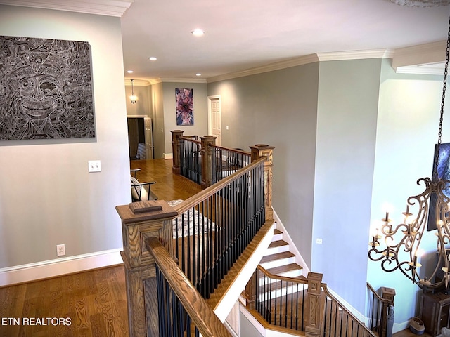 stairs featuring ornamental molding and hardwood / wood-style floors