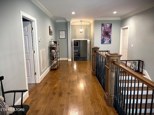 hallway featuring crown molding and dark hardwood / wood-style flooring