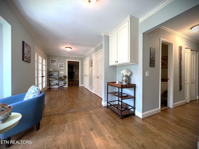 corridor with crown molding, hardwood / wood-style flooring, and french doors