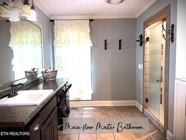 bathroom featuring tile patterned flooring, ornamental molding, a healthy amount of sunlight, and vanity