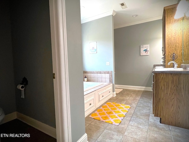 bathroom featuring ornamental molding, tile patterned flooring, a bathtub, and vanity