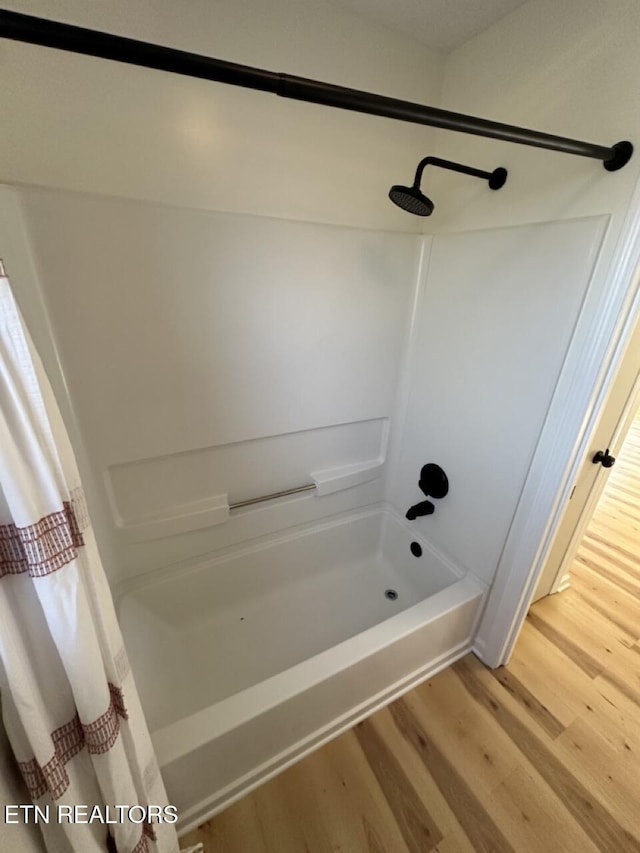 bathroom featuring shower / bath combo and hardwood / wood-style flooring