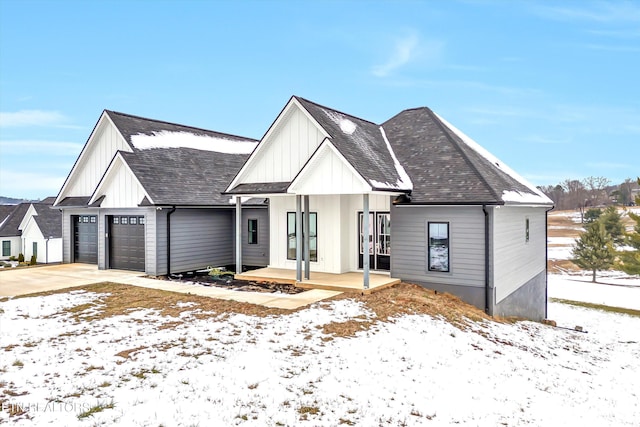 modern inspired farmhouse with covered porch and a garage