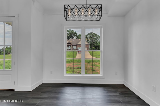 unfurnished dining area featuring dark wood-type flooring