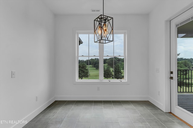 unfurnished dining area with a chandelier