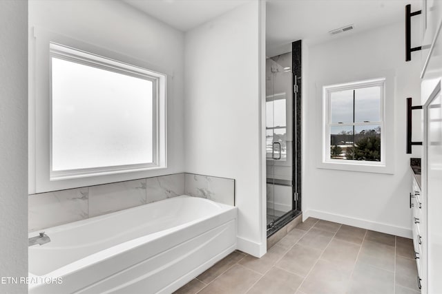 bathroom featuring tile patterned flooring, vanity, and separate shower and tub