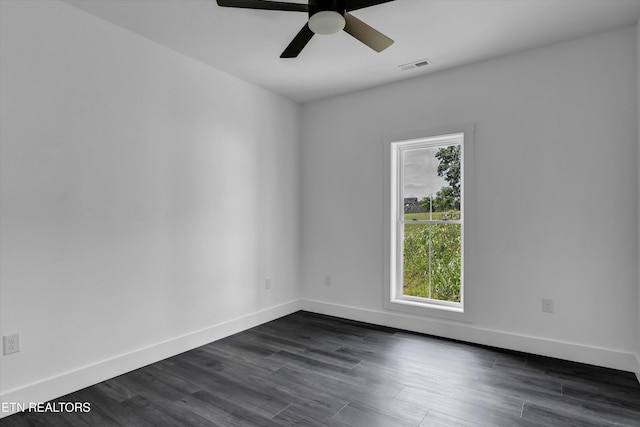 spare room with ceiling fan and dark wood-type flooring