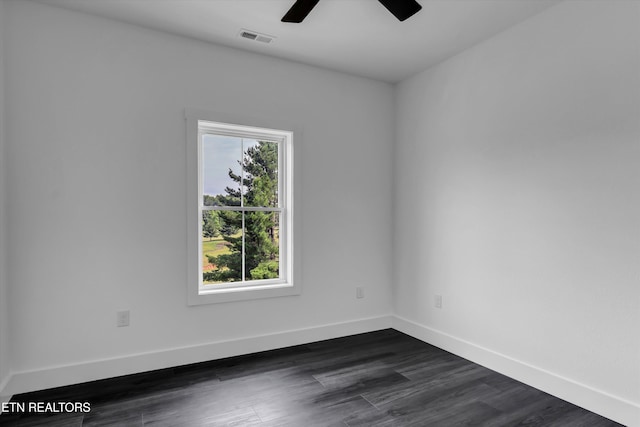 spare room with dark hardwood / wood-style floors and ceiling fan