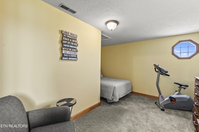 carpeted bedroom featuring a textured ceiling