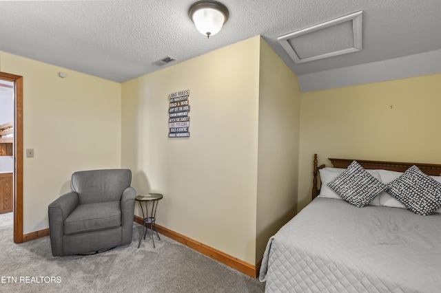 carpeted bedroom with a textured ceiling