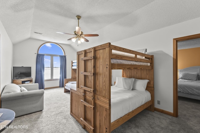 carpeted bedroom featuring lofted ceiling, ceiling fan, and a textured ceiling