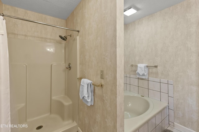 bathroom featuring curtained shower and a textured ceiling