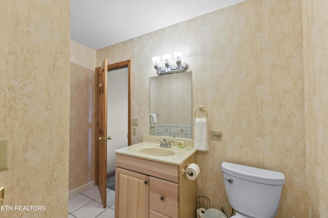 bathroom featuring tile patterned floors, toilet, a textured ceiling, and vanity