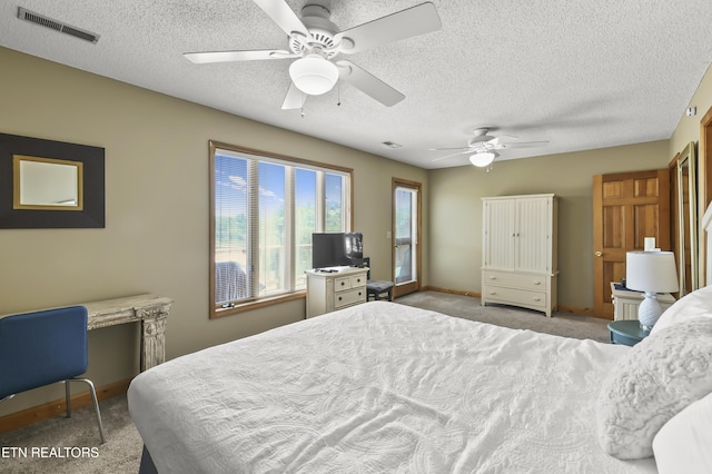 bedroom featuring light carpet, a textured ceiling, and ceiling fan