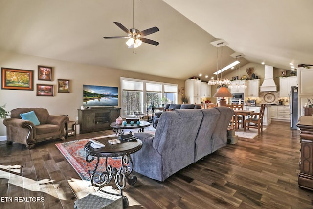 living room featuring ceiling fan, a large fireplace, lofted ceiling, and dark wood-type flooring