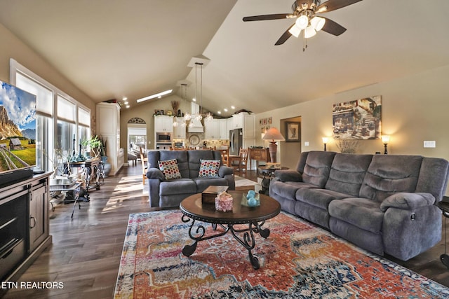 living room featuring ceiling fan, dark hardwood / wood-style flooring, and vaulted ceiling