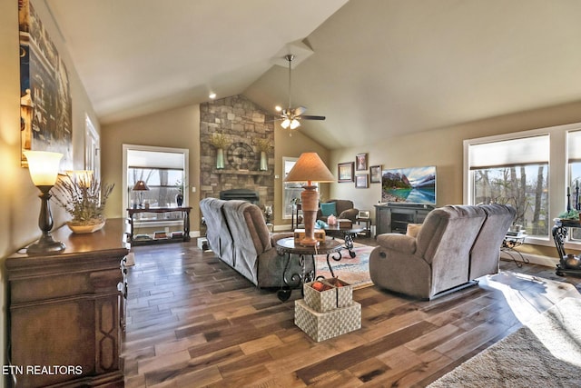 living room with a stone fireplace, ceiling fan, dark hardwood / wood-style flooring, and lofted ceiling