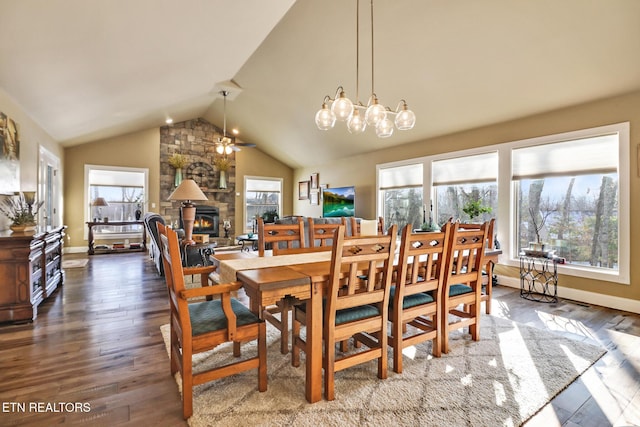 dining space featuring ceiling fan, a fireplace, lofted ceiling, and hardwood / wood-style flooring