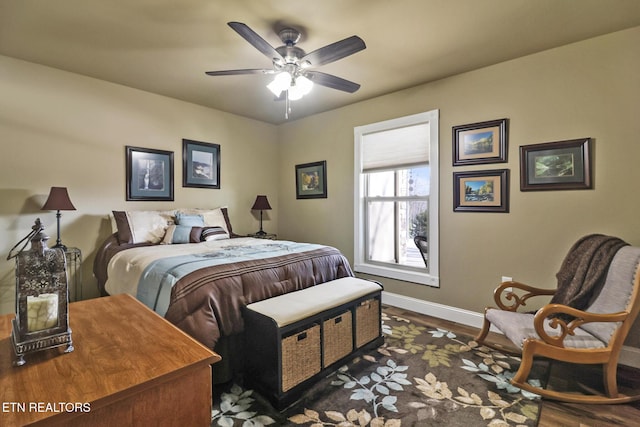 bedroom with dark hardwood / wood-style floors and ceiling fan