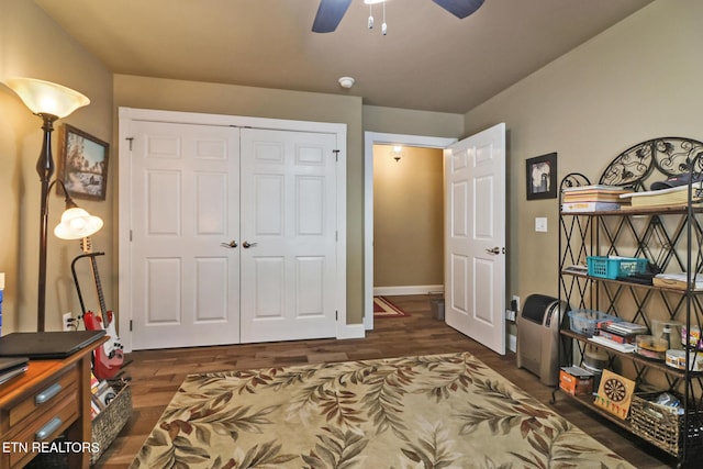 interior space with ceiling fan, a closet, and dark hardwood / wood-style floors