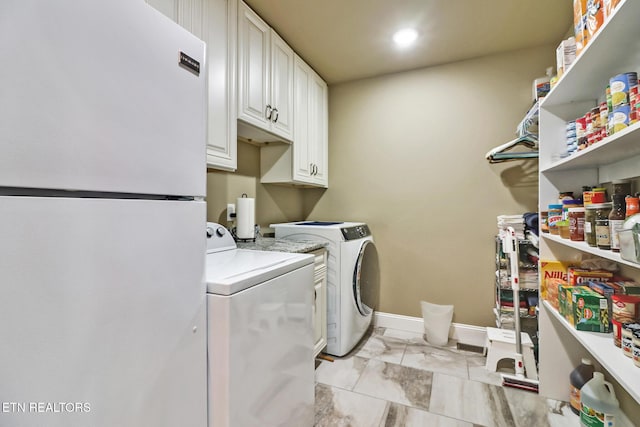 laundry room with cabinets and separate washer and dryer