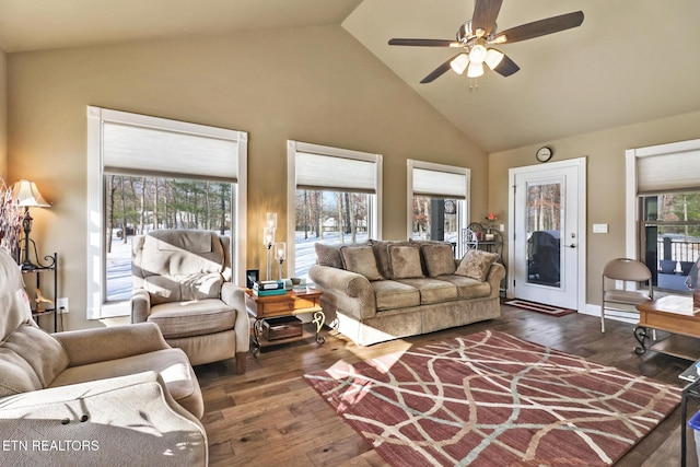 living room with dark hardwood / wood-style floors, ceiling fan, and high vaulted ceiling