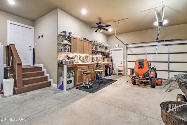 garage with a workshop area and ceiling fan