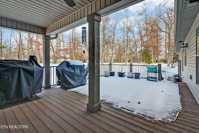 snow covered deck featuring ceiling fan and a grill