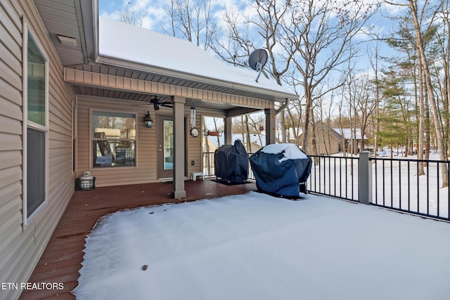 snow covered patio with ceiling fan, a porch, and a grill