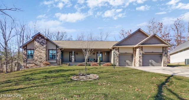 view of front of house with a garage, a front yard, and cooling unit