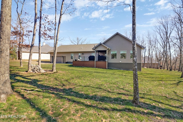 rear view of house featuring a lawn