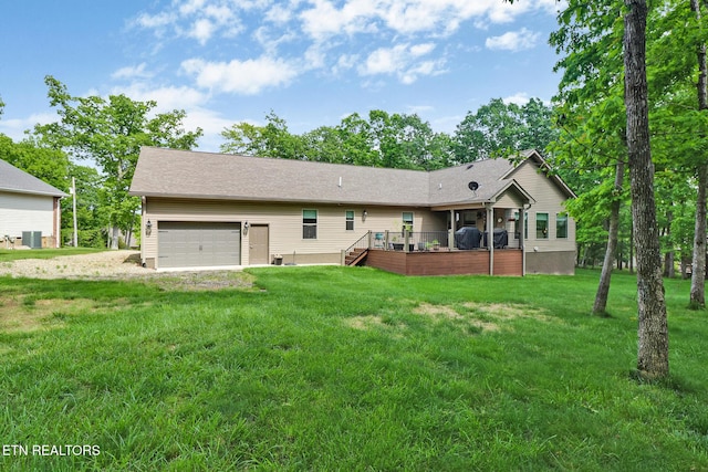 153 Walden Ridge Dr, Fairfield Glade, TN 38558 - rear view of house with a lawn and an attached garage