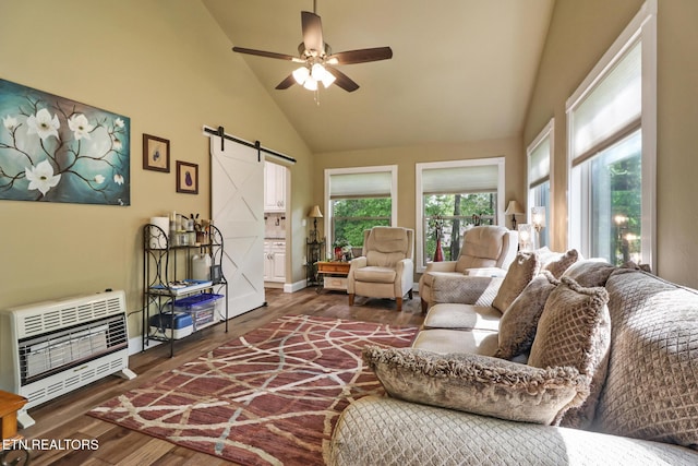 153 Walden Ridge Dr, Fairfield Glade, TN 38558 - living area with heating unit, a barn door, high vaulted ceiling, wood finished floors, and a ceiling fan