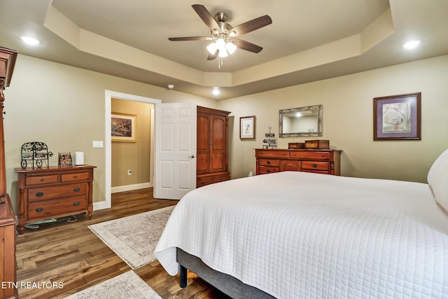 153 Walden Ridge Dr, Fairfield Glade, TN 38558 - bedroom with a tray ceiling, recessed lighting, wood finished floors, baseboards, and a ceiling fan