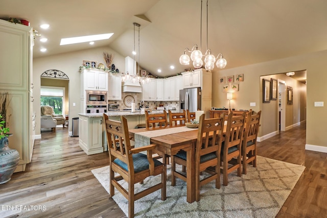 153 Walden Ridge Dr, Fairfield Glade, TN 38558 - dining area with a skylight, dark wood-style flooring, baseboards, and high vaulted ceiling