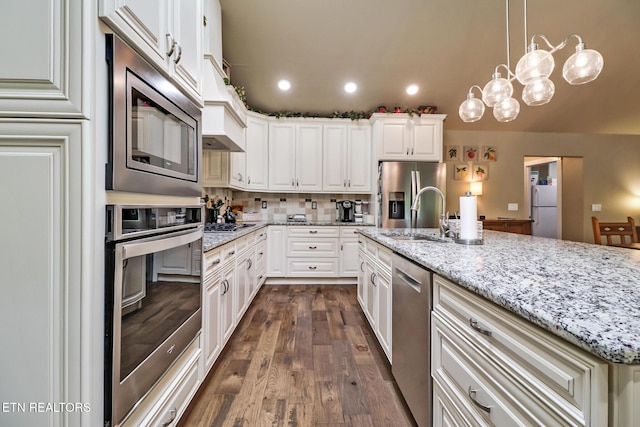 153 Walden Ridge Dr, Fairfield Glade, TN 38558 - kitchen with appliances with stainless steel finishes, a sink, dark wood-style floors, recessed lighting, and light stone countertops