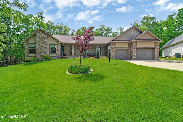 153 Walden Ridge Dr, Fairfield Glade, TN 38558 - view of front of property featuring stone siding, a front lawn, a garage, driveway, and stucco siding