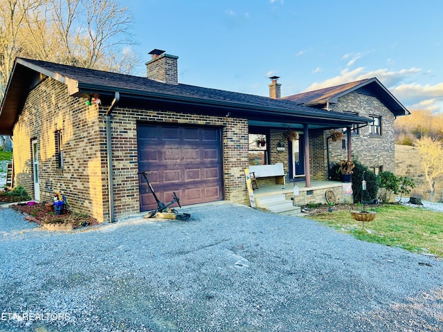 view of front of home featuring a porch and a garage