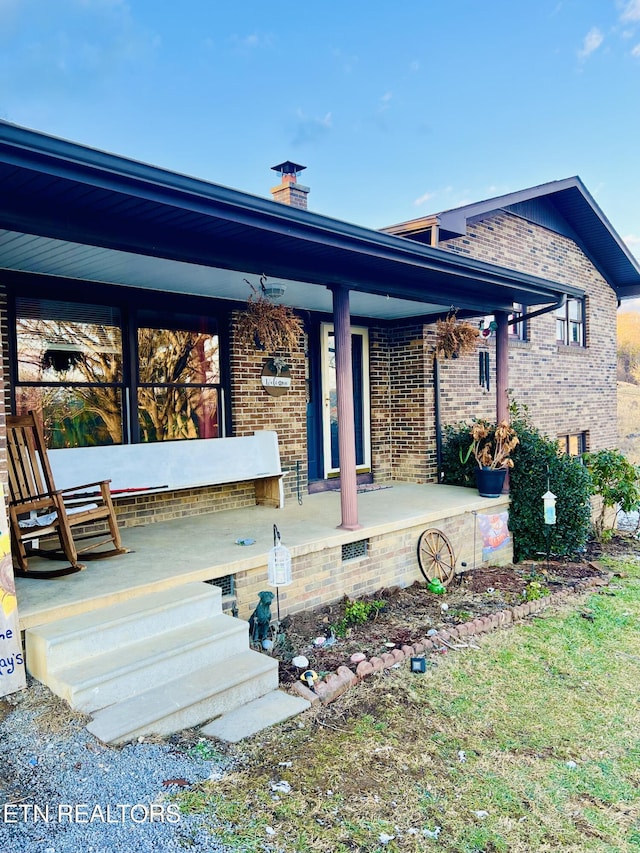 rear view of house with covered porch