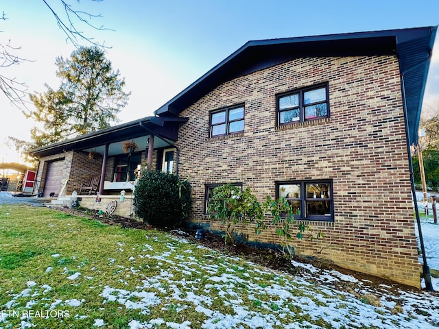 exterior space featuring a lawn and a garage