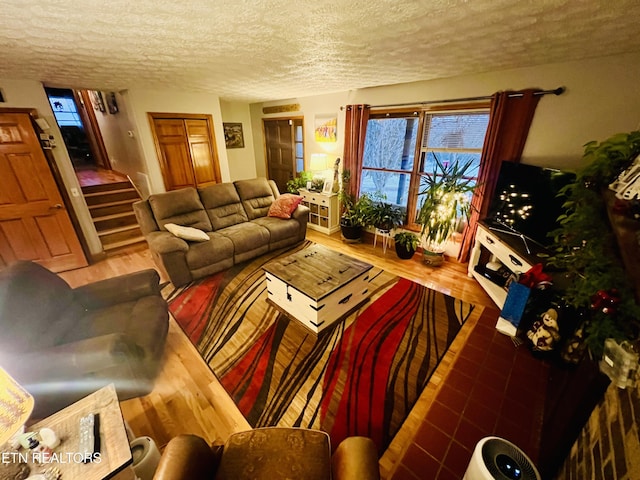 living room with hardwood / wood-style floors and a textured ceiling