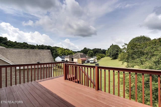 wooden deck featuring a yard