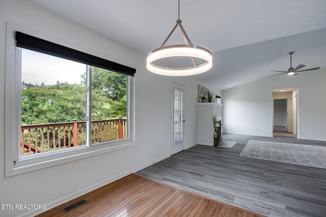 spare room with ceiling fan, hardwood / wood-style floors, and vaulted ceiling