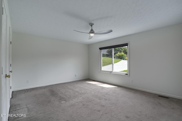 carpeted empty room with a textured ceiling and ceiling fan