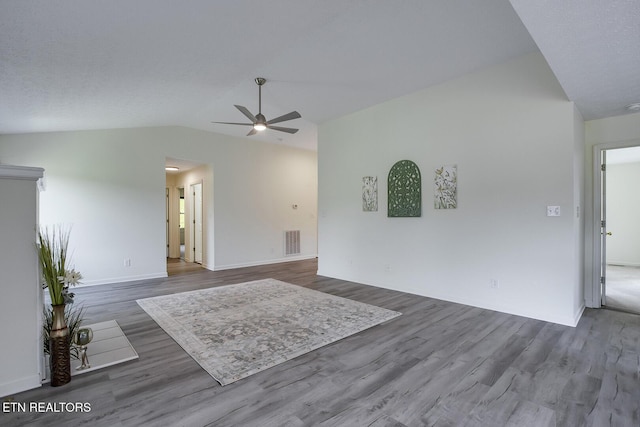 spare room featuring ceiling fan, vaulted ceiling, and dark hardwood / wood-style flooring