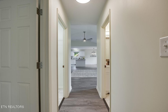 hallway with light hardwood / wood-style flooring