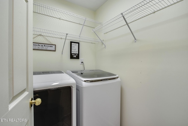 laundry room with washing machine and clothes dryer