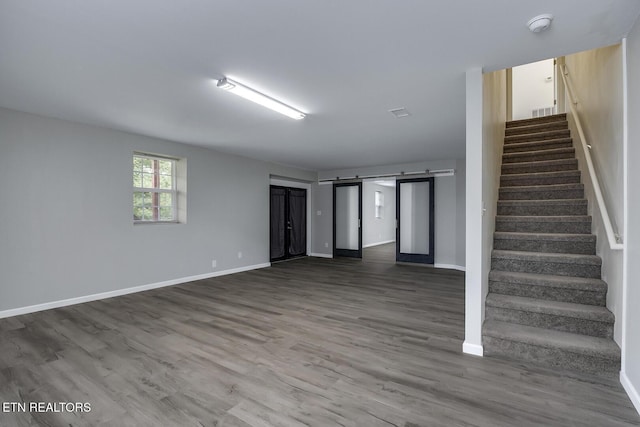 interior space with hardwood / wood-style flooring and a barn door