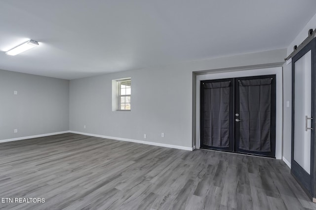 interior space featuring a barn door and hardwood / wood-style flooring