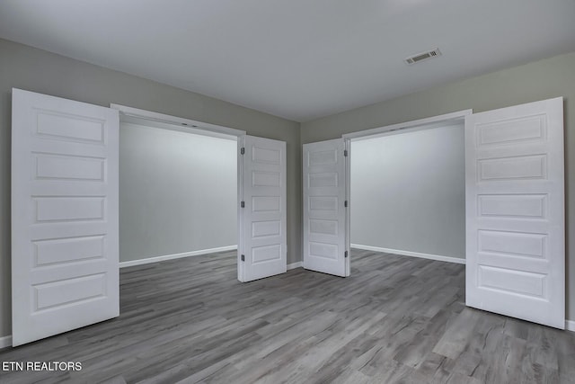 unfurnished bedroom with a closet and light hardwood / wood-style floors